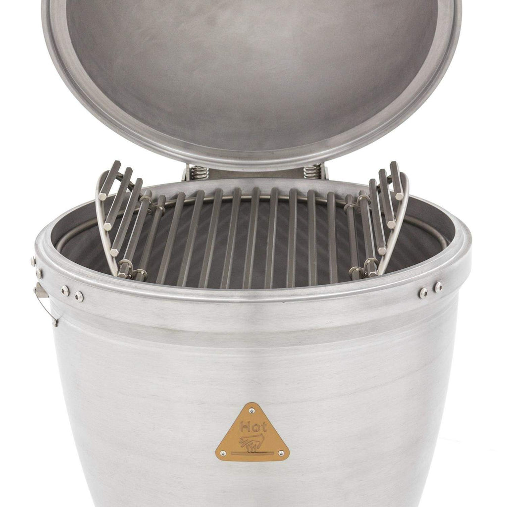 Cast aluminum kamado grill open with cooking grate and raised heat deflector