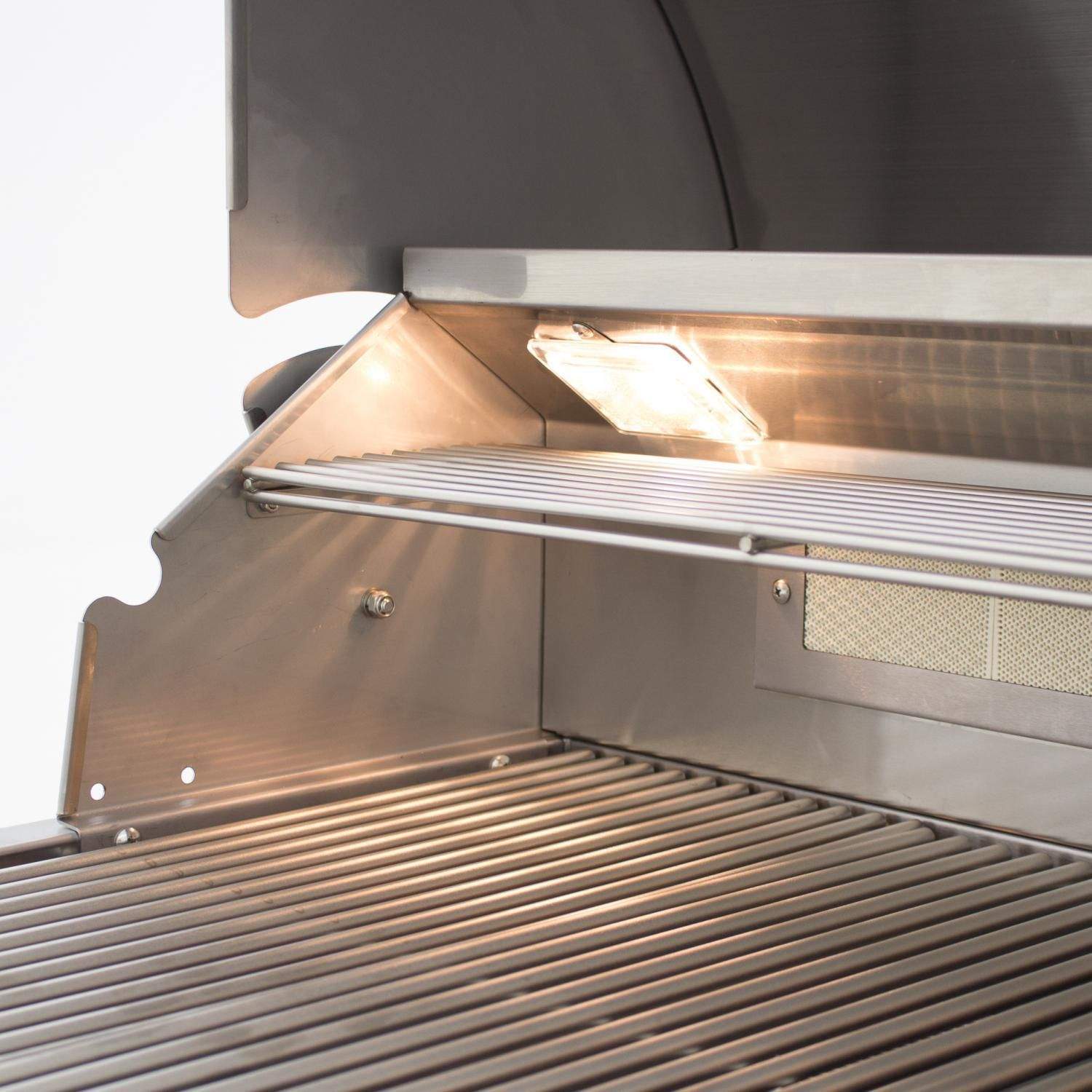 Built-in gas grill interior with warming area and glowing light