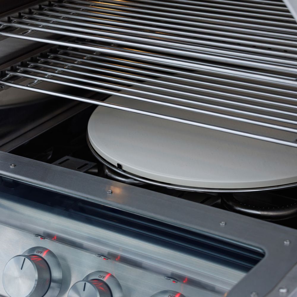 Indoor cooking chamber with metal grill grates and heating element beneath hood