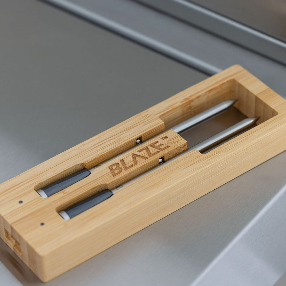 Bamboo pizza peel tool set with Blaze logo on a wooden serving tray