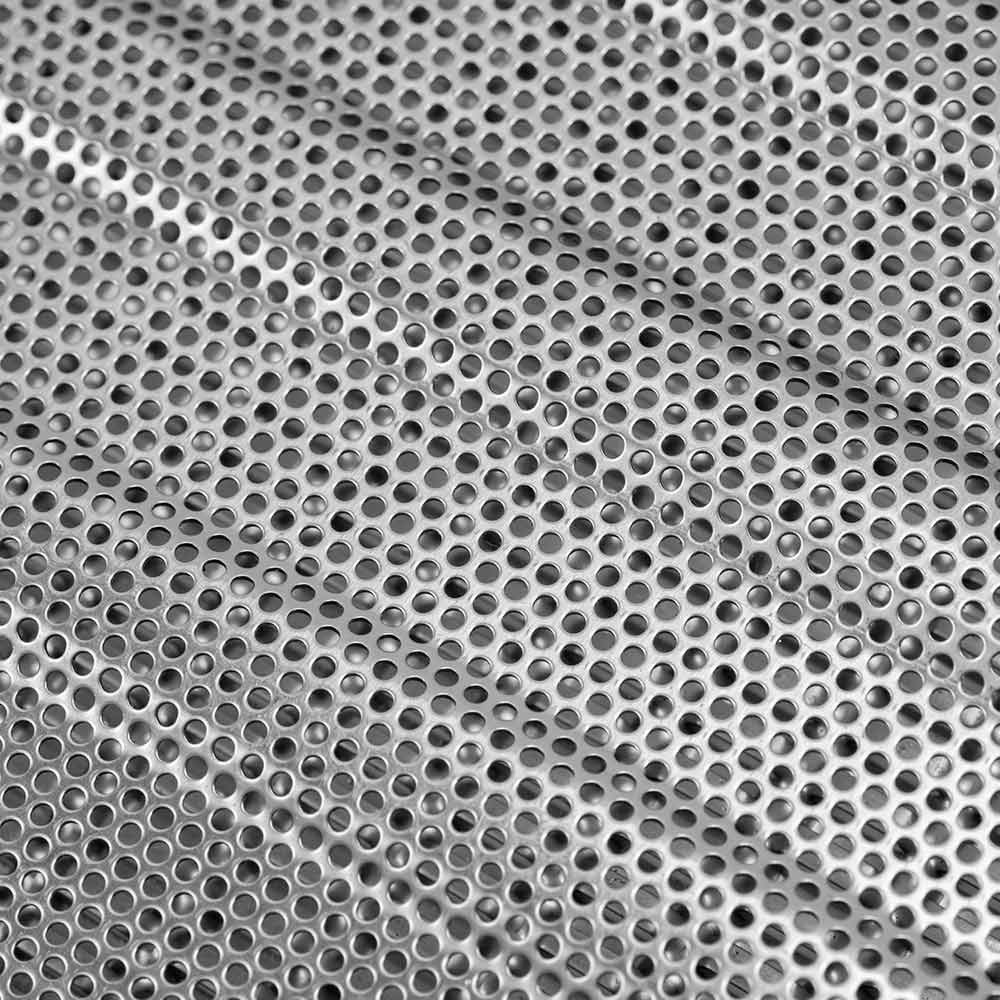 Close-up of round perforations in stainless flame tamer