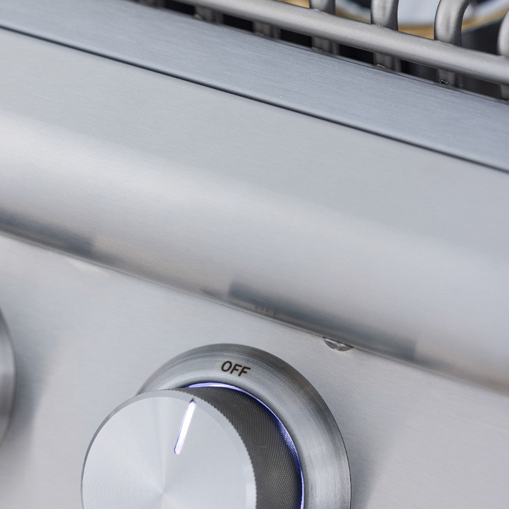 Stainless steel side burner control knob set to OFF on the control panel