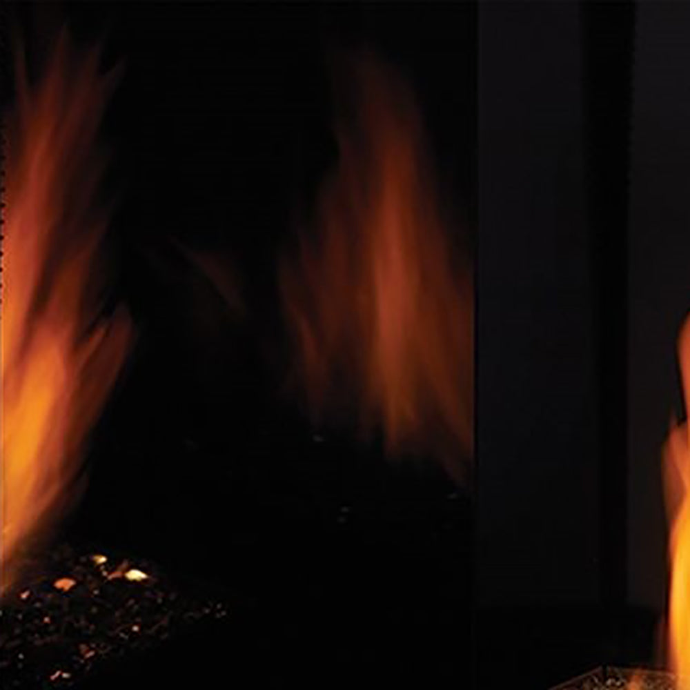 Reflective black glass liner panel for a firebox opening