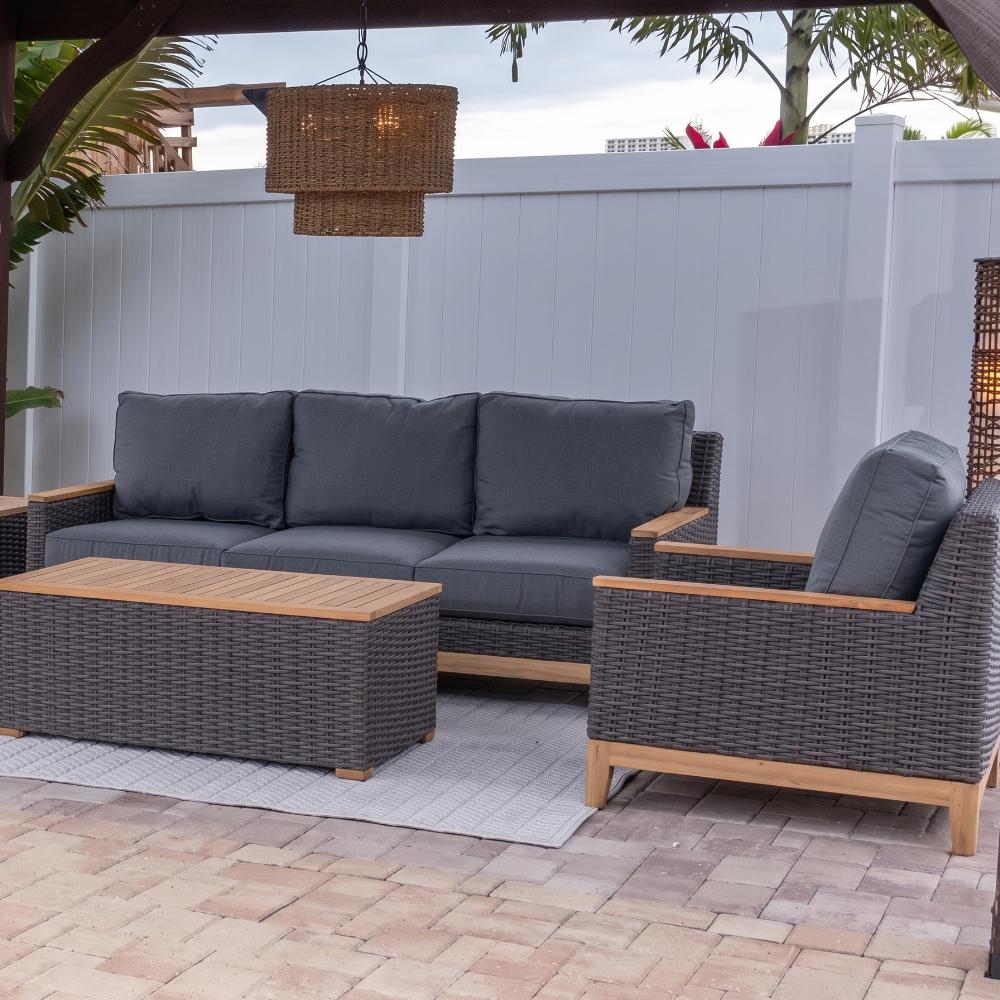 Outdoor club chairs with dark woven frames and dark gray cushions