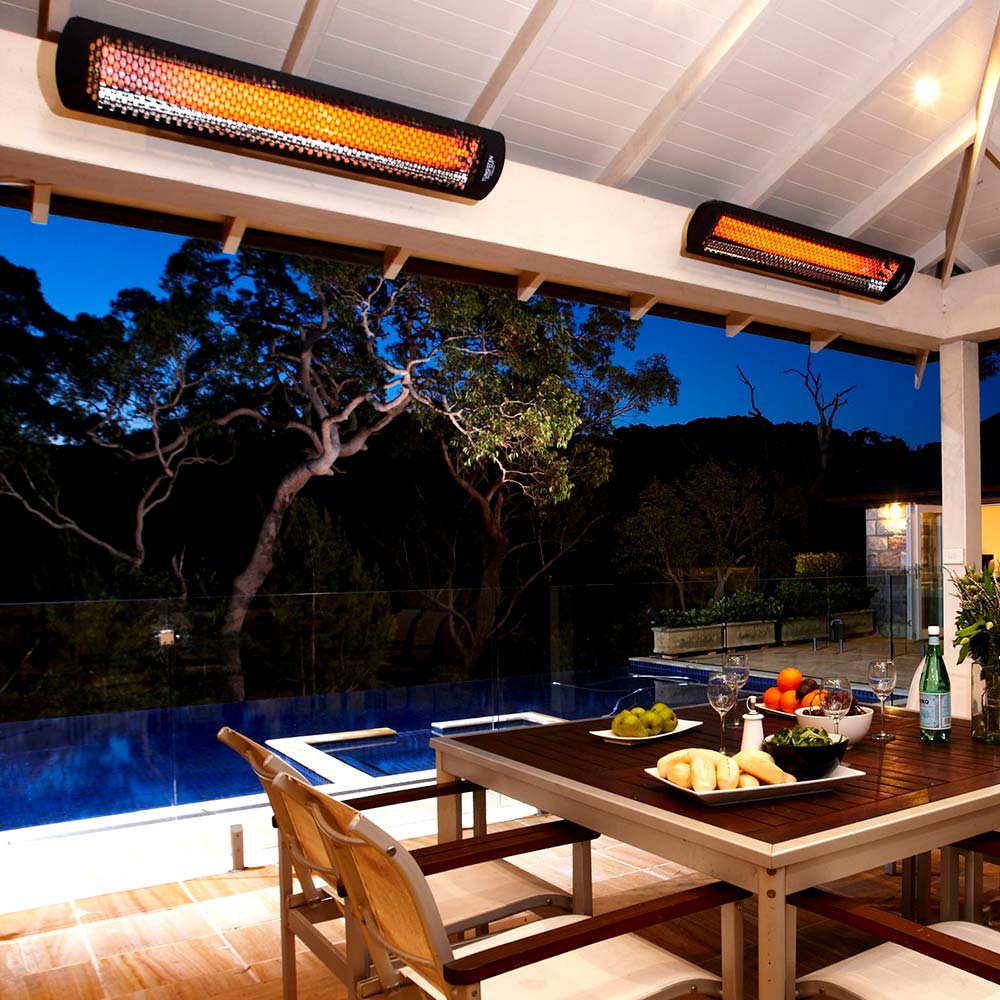 Black electric patio heater mounted overhead with glowing heating bars