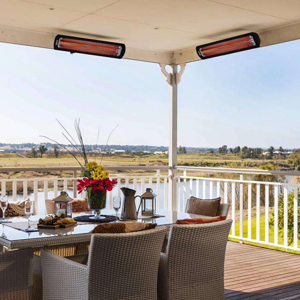 Ceiling-mounted black electric patio heater with glowing orange heating tubes