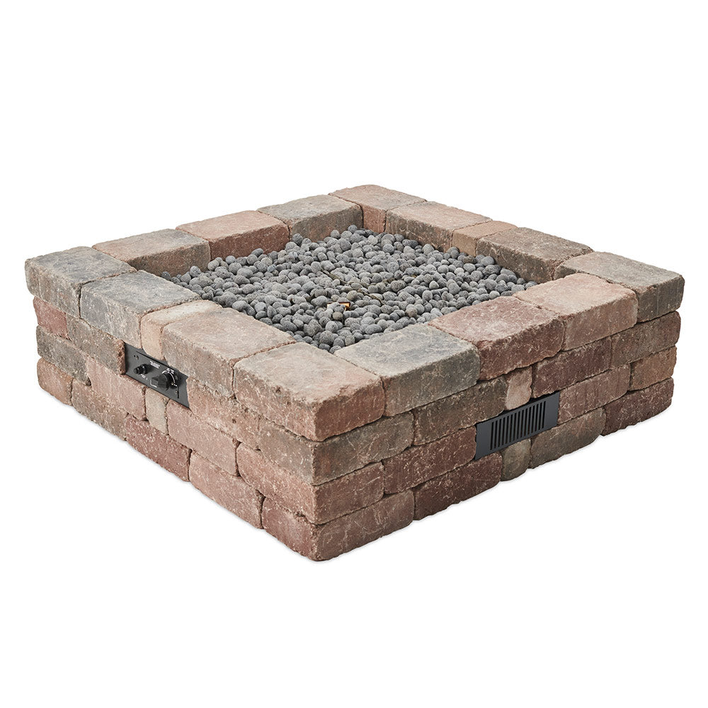 Square stone gas fire pit with gray lava rocks in the open center