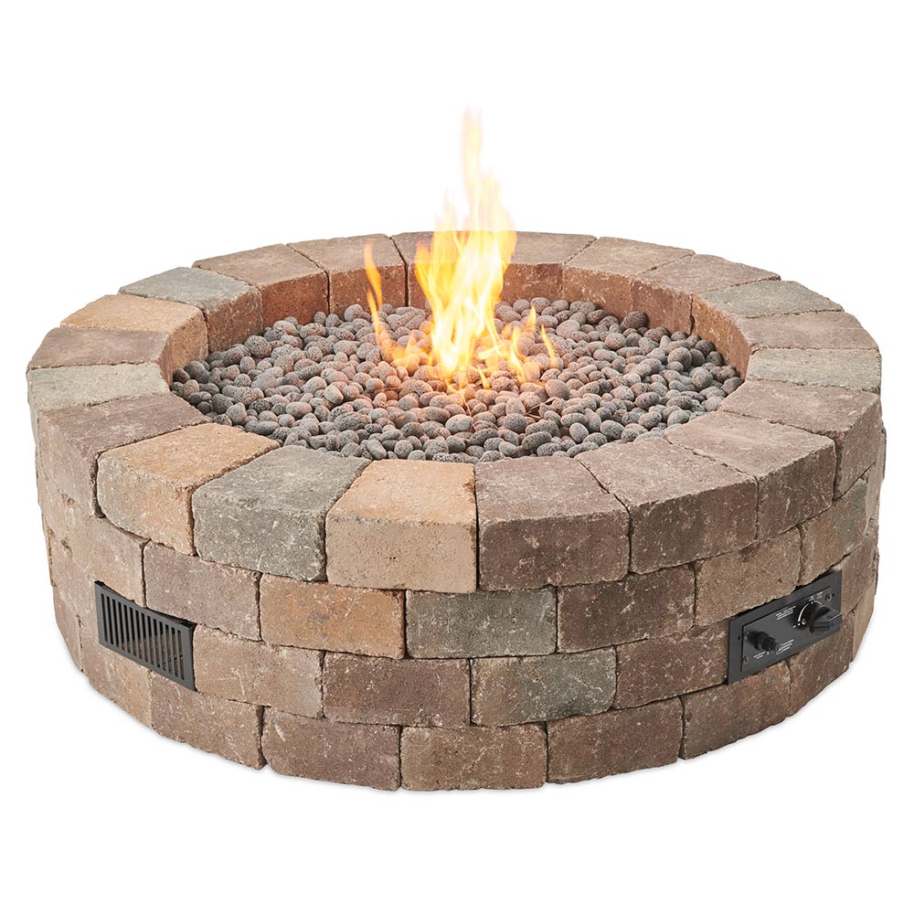 Round gas fire pit kit with stone block ring and burning flame over lava rocks