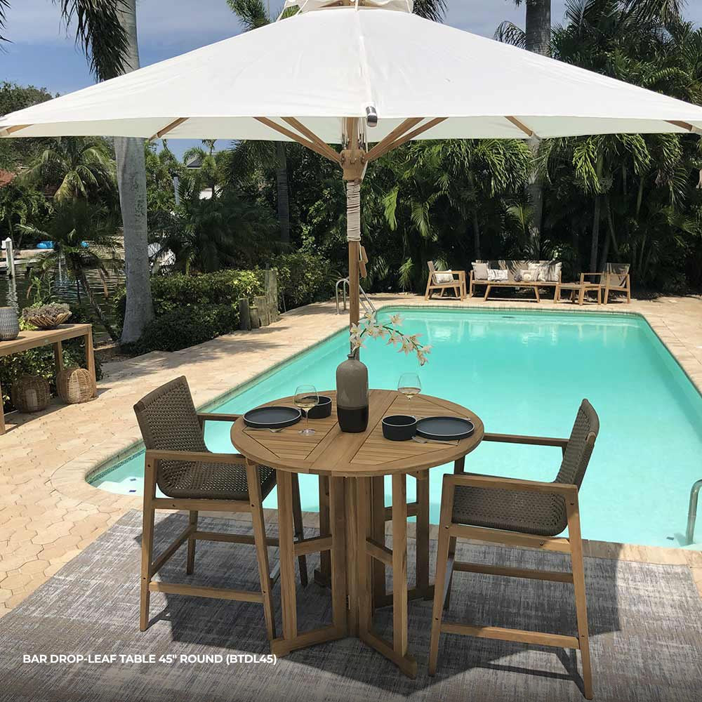 Round drop-leaf teak bar table with slatted top and open drop leaves