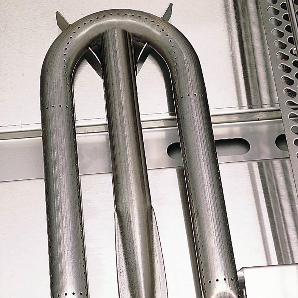 Stainless U-shaped burner tubes above the grill firebox