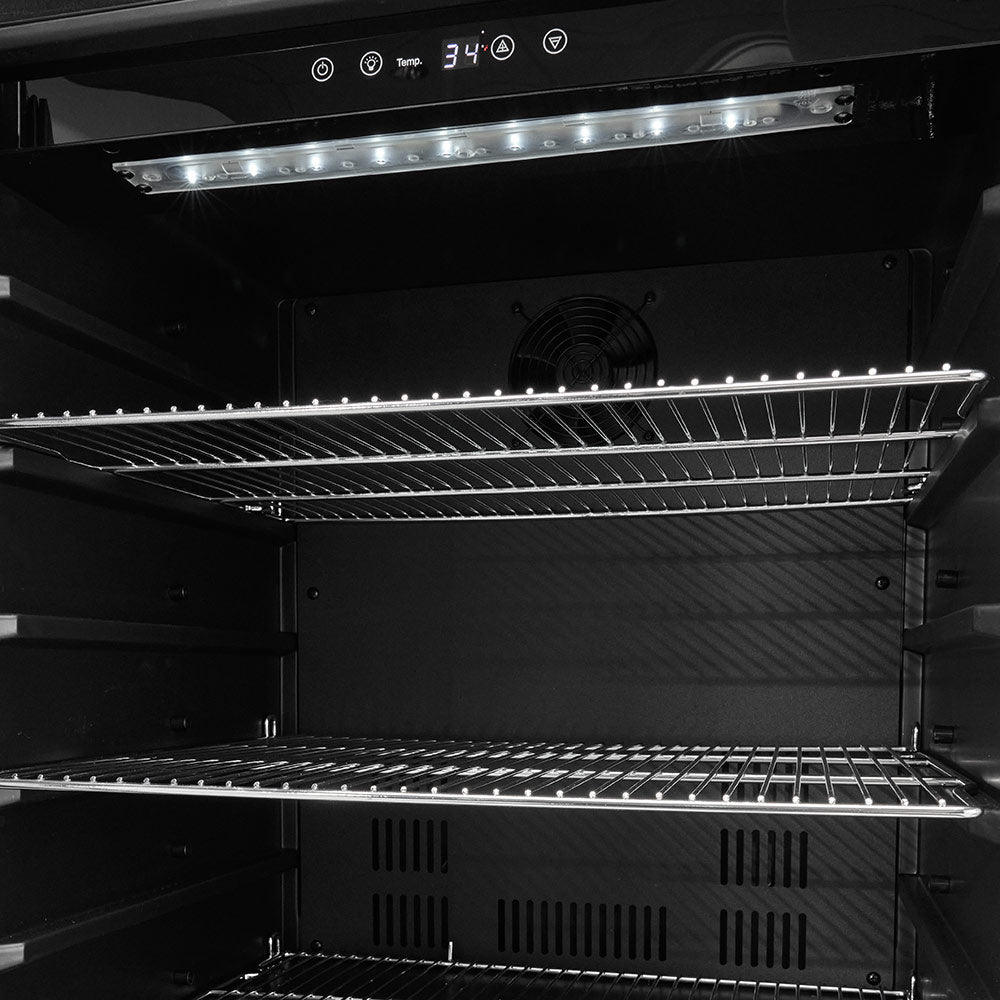 Interior of 24-inch refrigerator showing wire shelves and overhead light bar