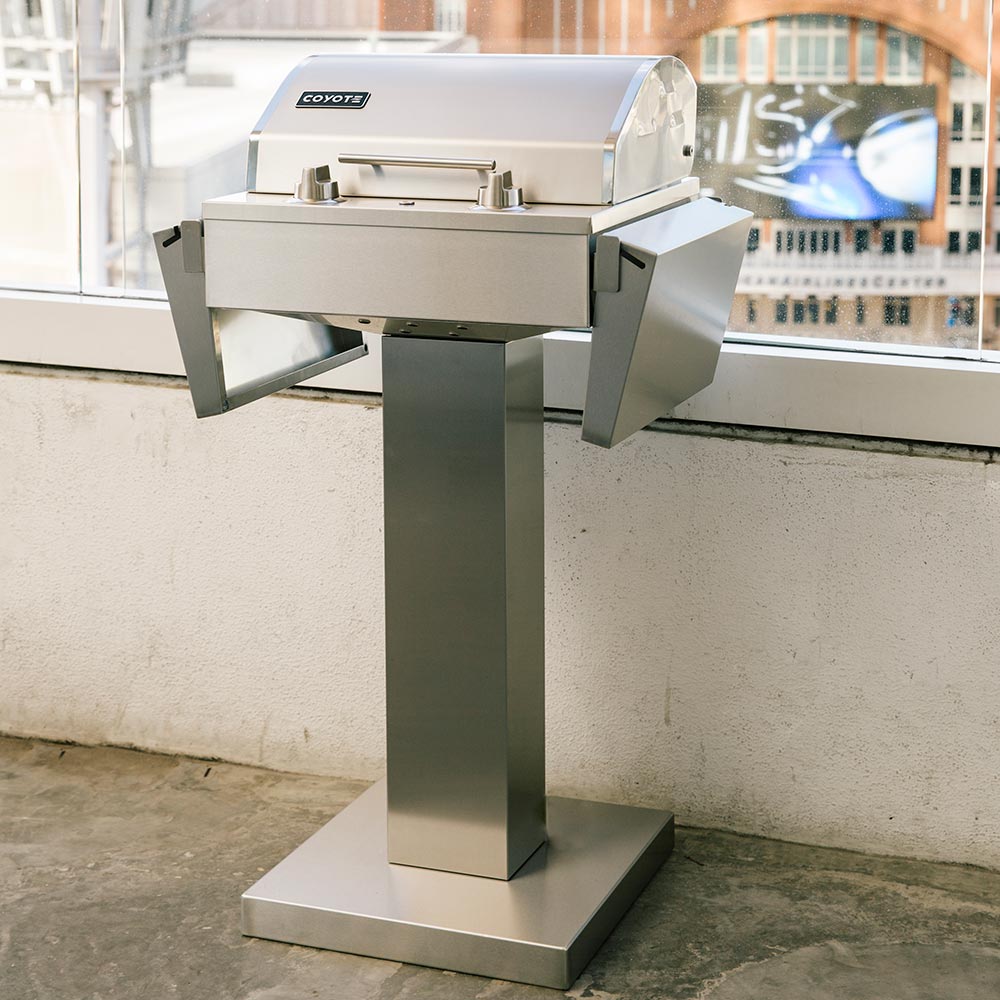 Stainless steel electric grill pedestal with lid closed and side handles