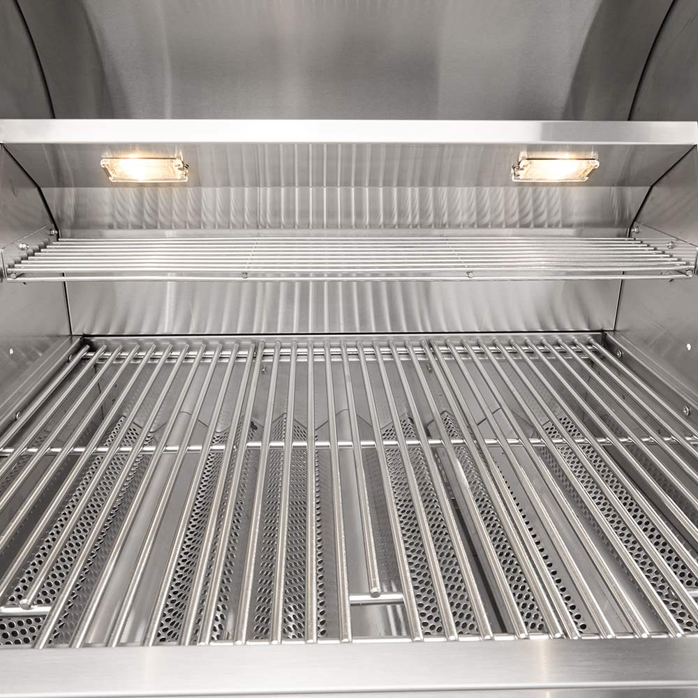 Gas grill firebox with stainless steel rod cooking grates and overhead halogen lights