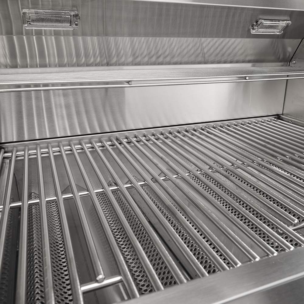 Gas grill cooking area with stainless steel grates and radiant metal bars