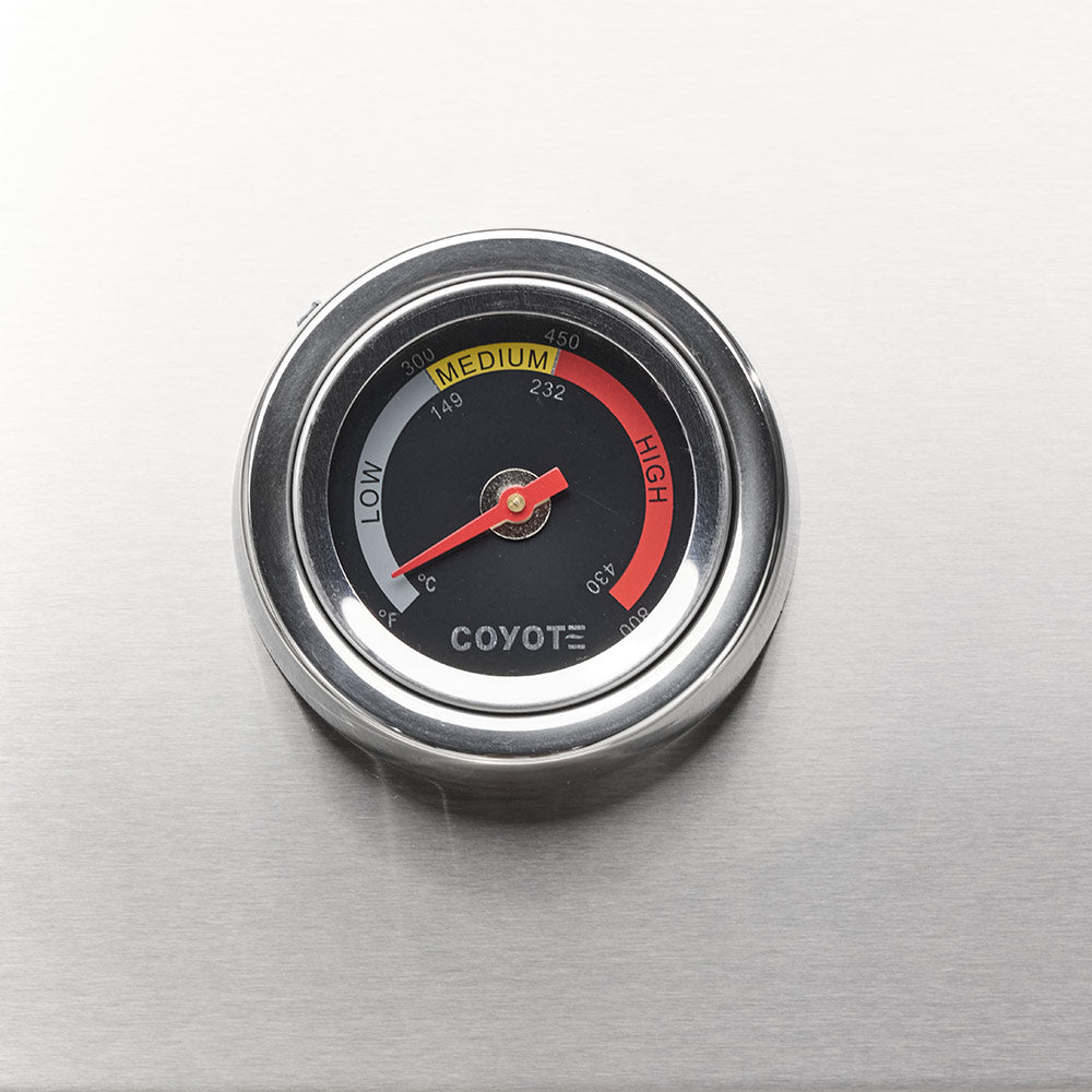 Coyote temperature gauge showing LOW to HIGH range on stainless steel