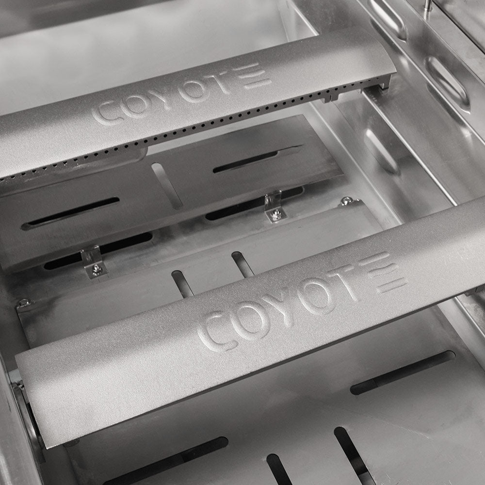 Stainless steel burner covers with Coyote logo and ignition slot openings