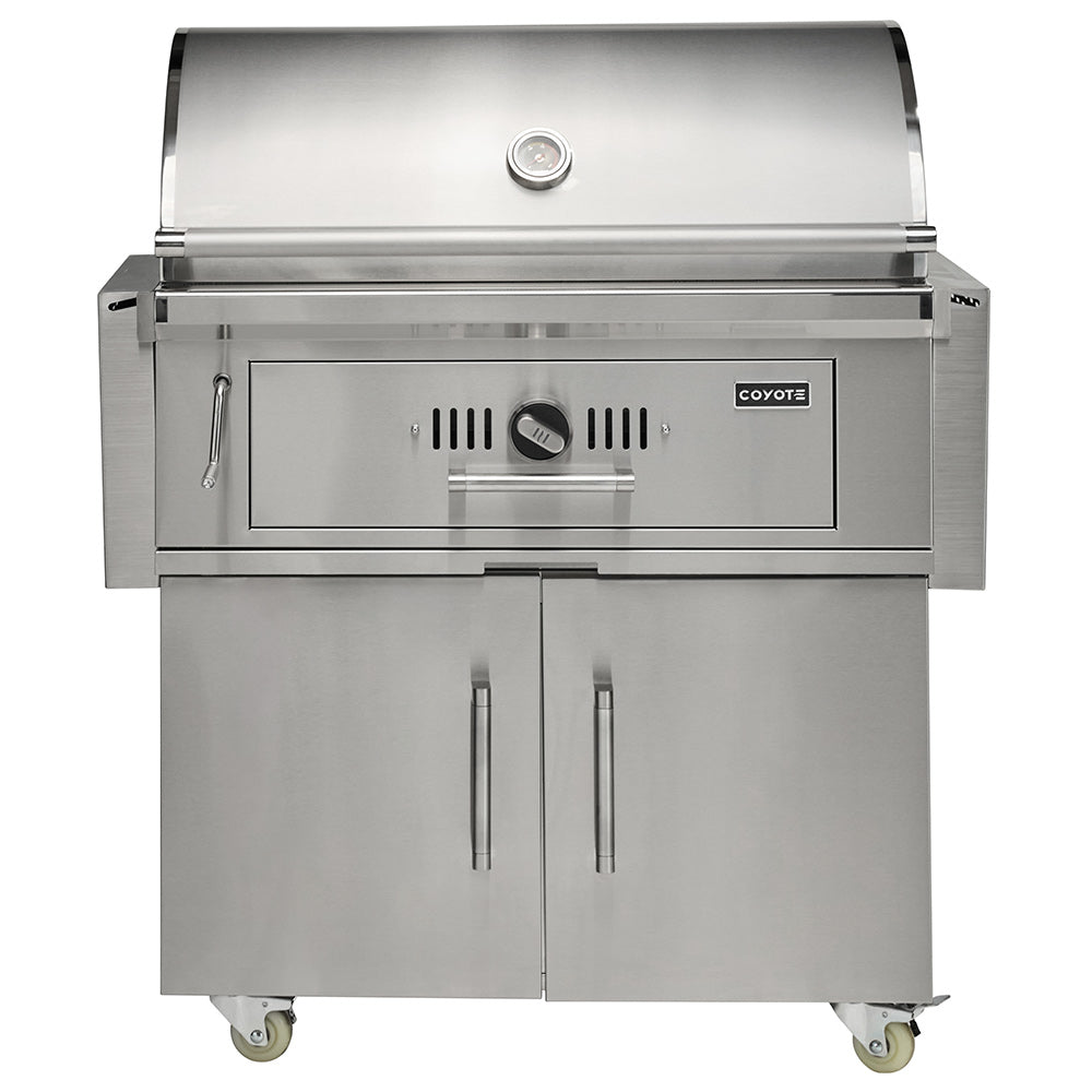 Stainless steel freestanding charcoal grill with front control panel and side tools