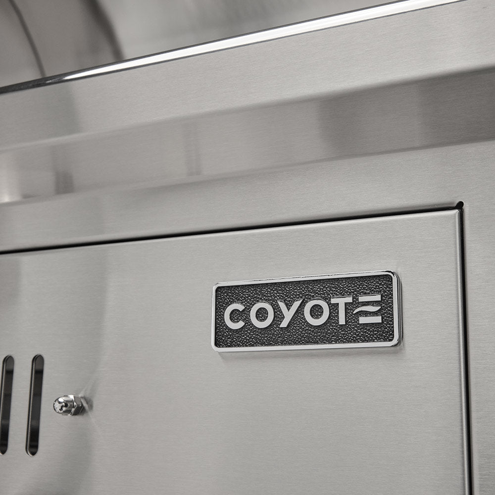 COYOTE logo badge on stainless steel grill side panel