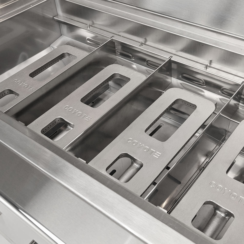 Stainless steel burner tray with integrated gas channels and control module cutouts