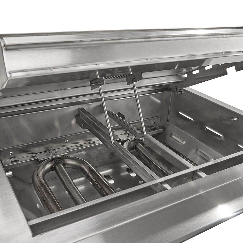 Stainless steel grill burner area with metal manifold and ignition components inside