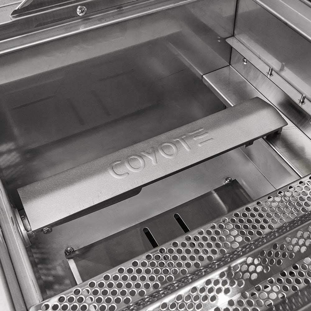 Stainless steel warming drawer with Coyote logo and perforated grease tray