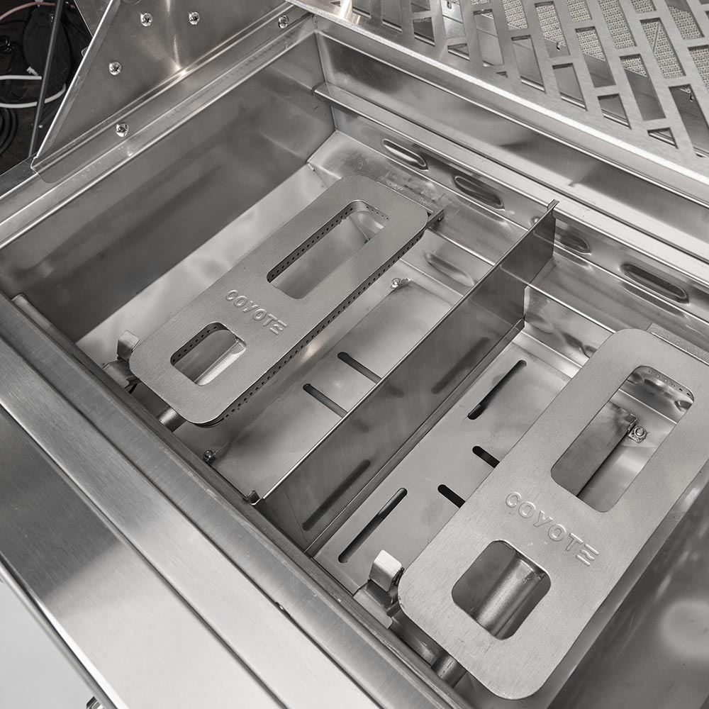 Open grill firebox with stainless steel grates, burners, and side warming areas