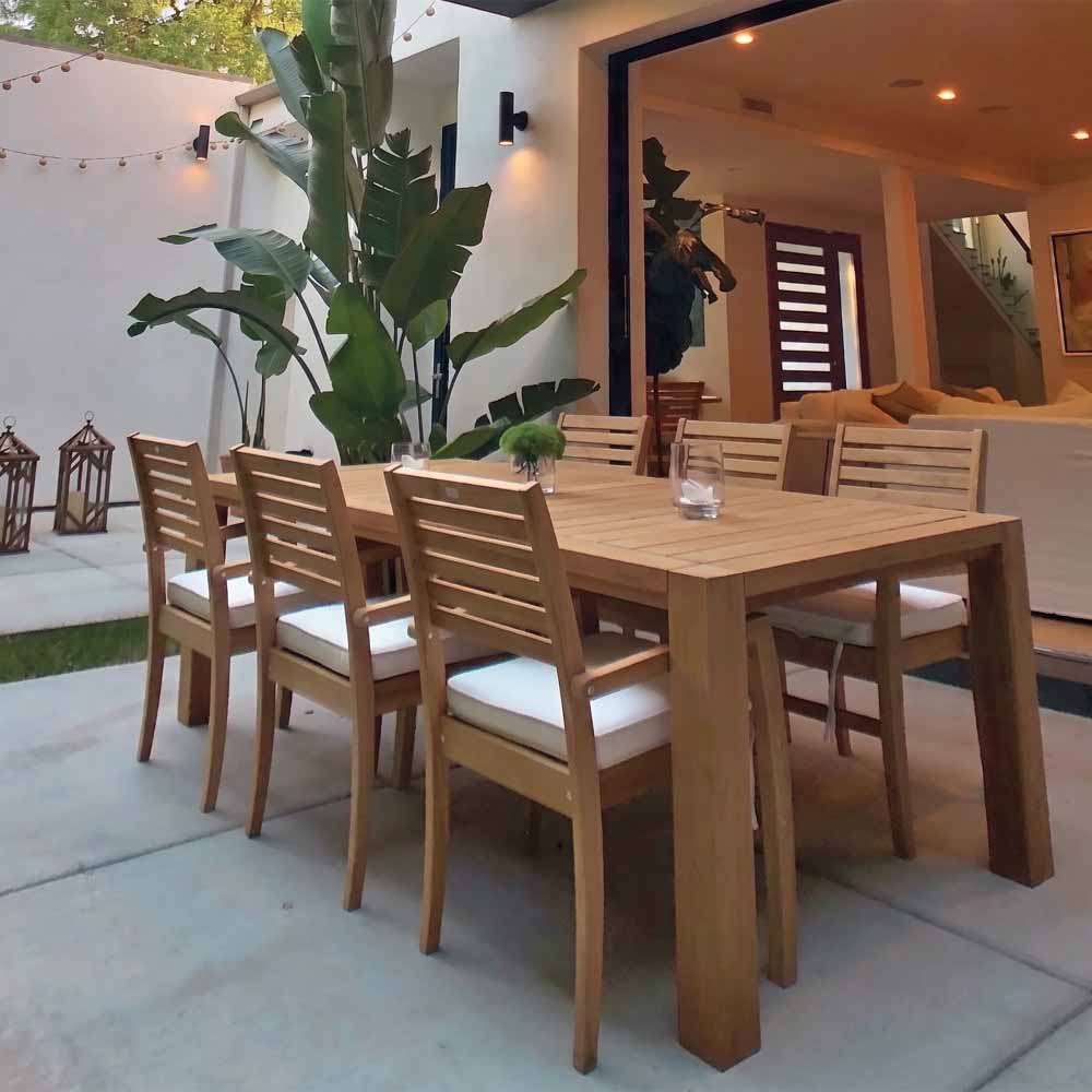 Teak dining chair with slatted back and white seat cushion