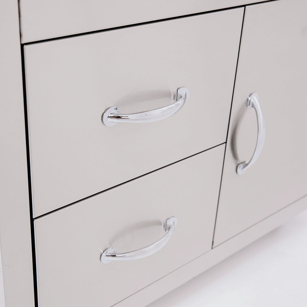 White cabinet drawers with chrome pull handles on outdoor grill cart