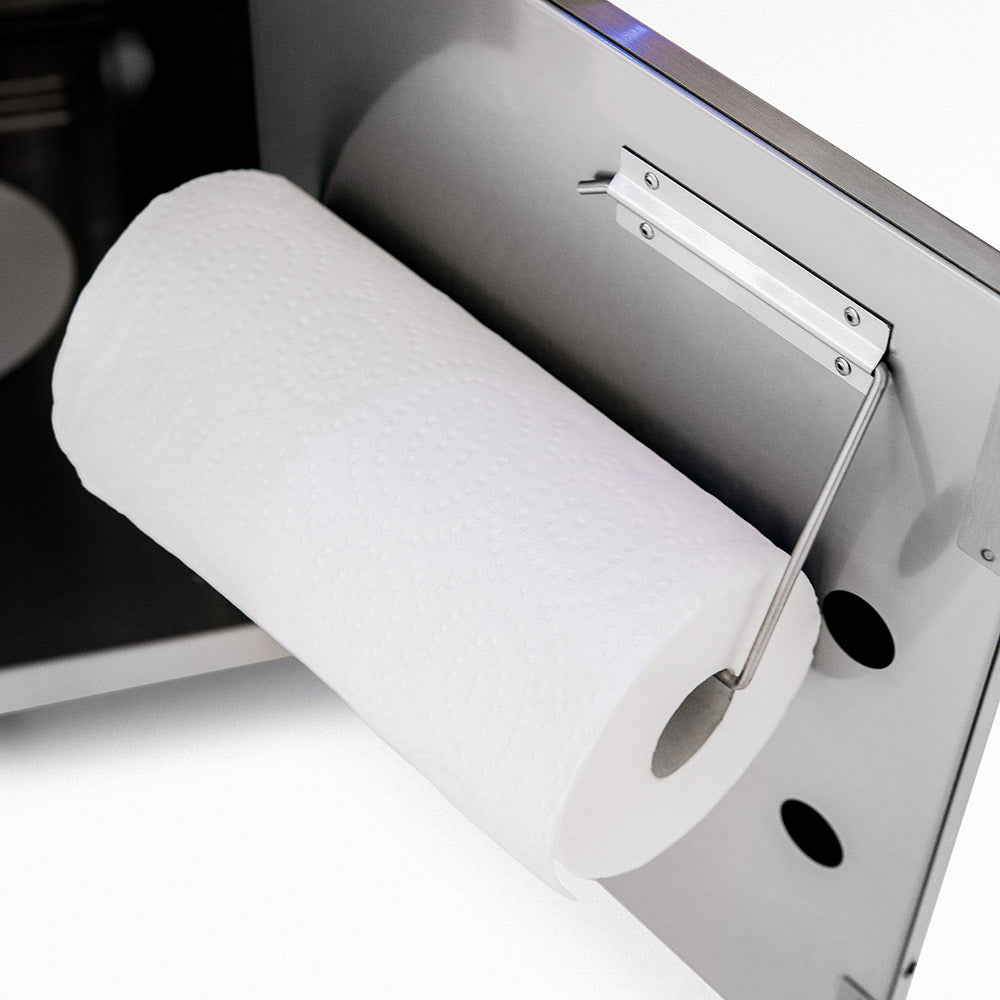 White paper towel holder mounted on side panel of outdoor grill cart