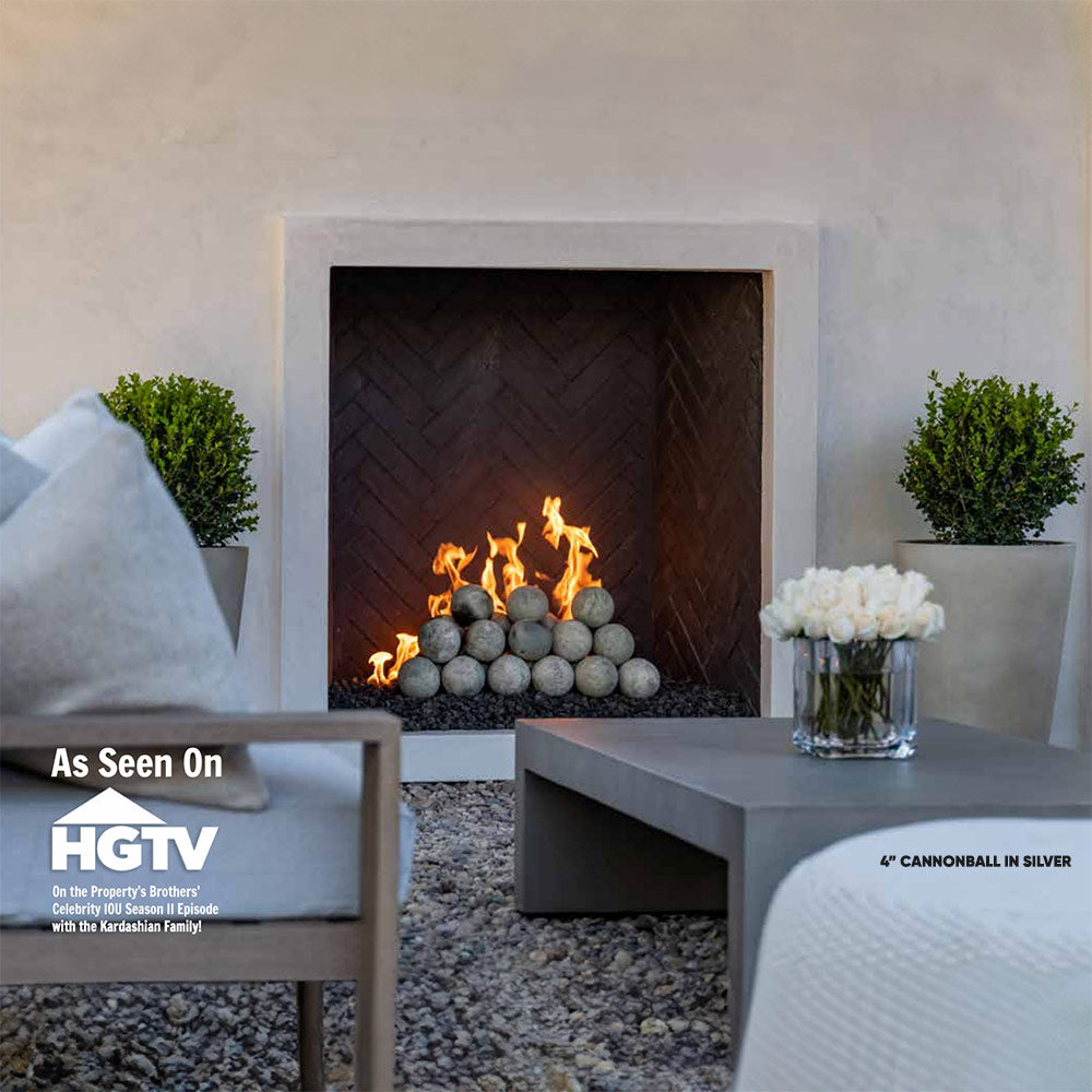 Silver fireplace cannon balls: smooth round spheres stacked in a fire pit