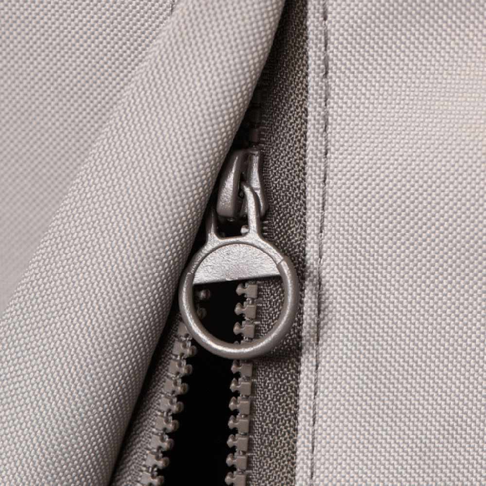 Light gray vinyl cover zipper with metal pull ring and stitched seam