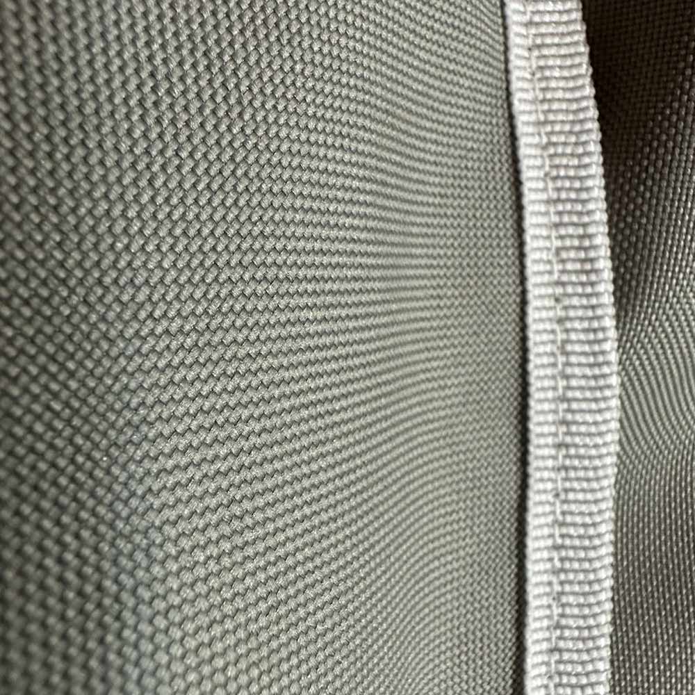 Light gray vinyl cover edge with textured weave and stitched trim
