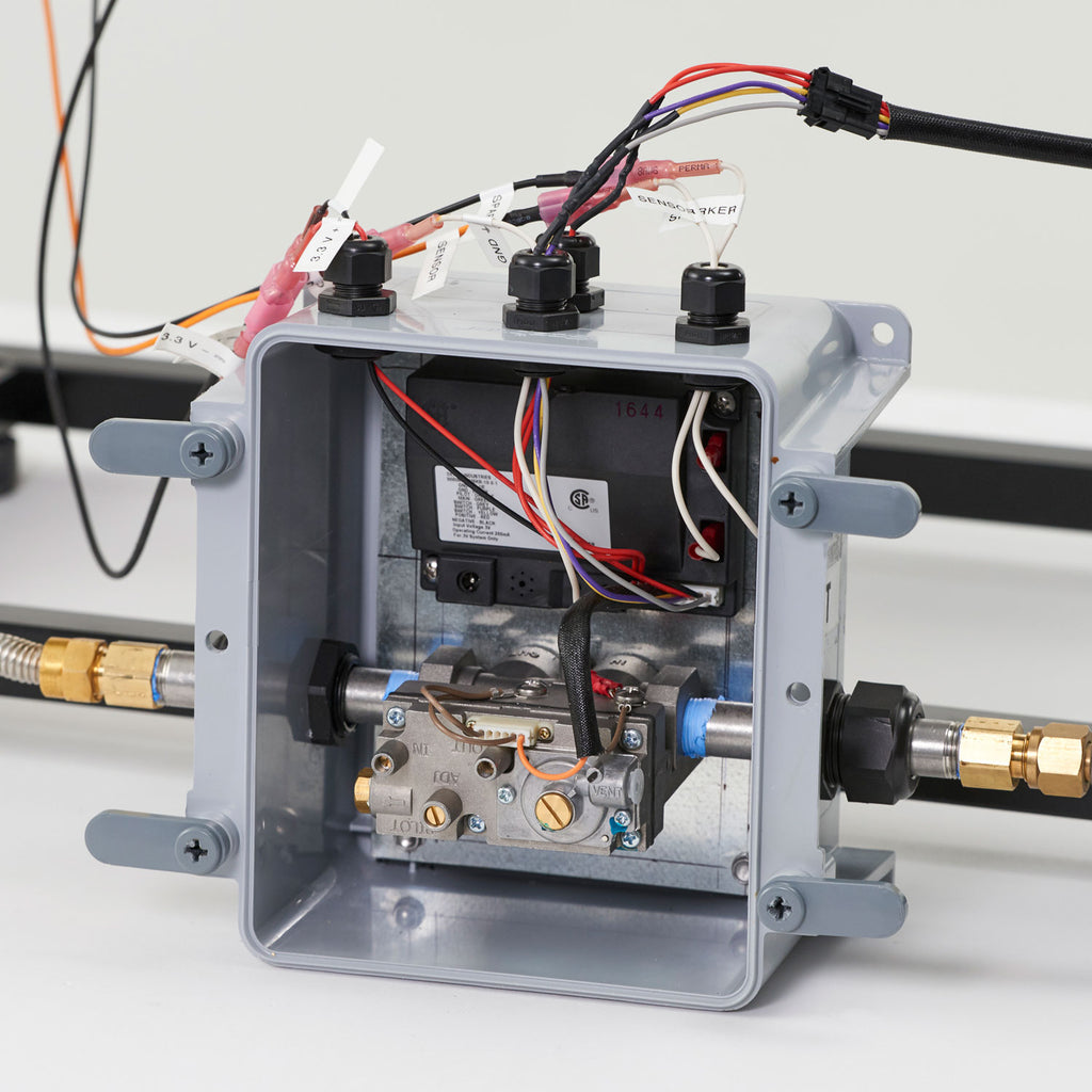 Gas fire pit ignition control box with open cover and internal components