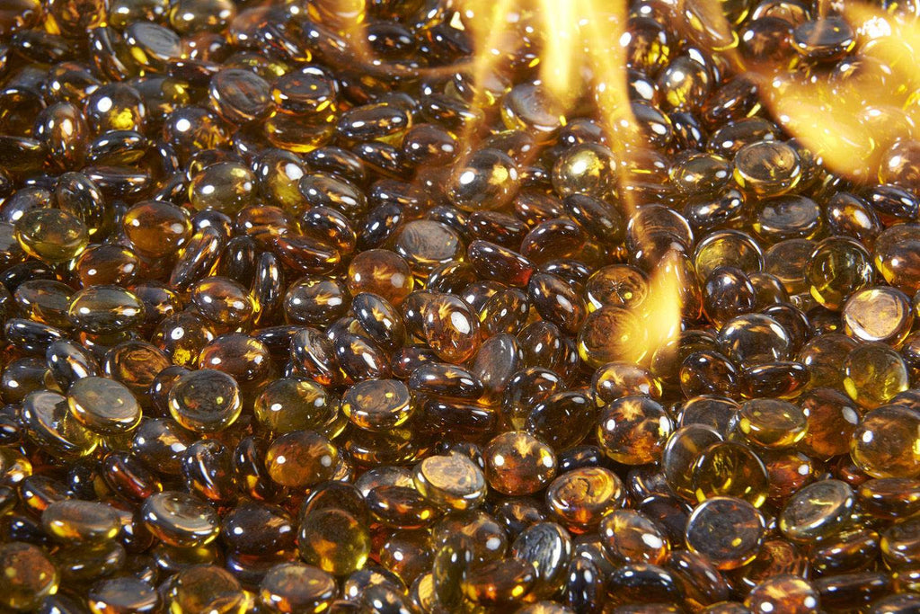 Close-up of amber fire glass gems, round translucent crystals