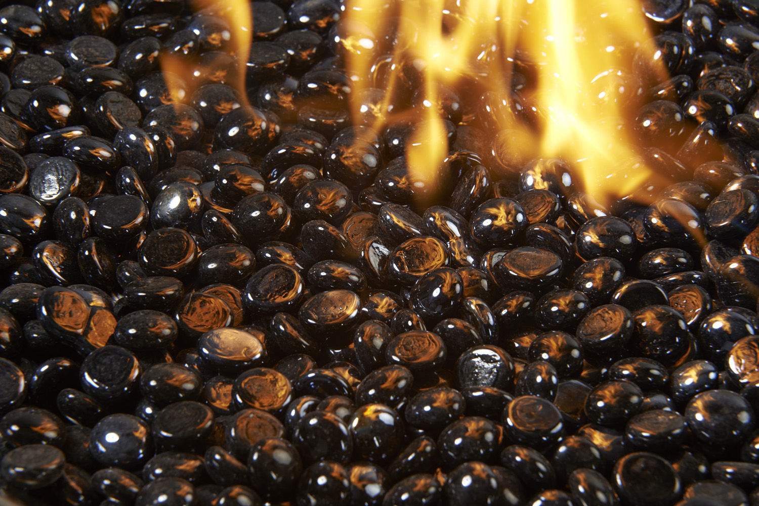 Onyx black fire glass gems with flames rising among the stones