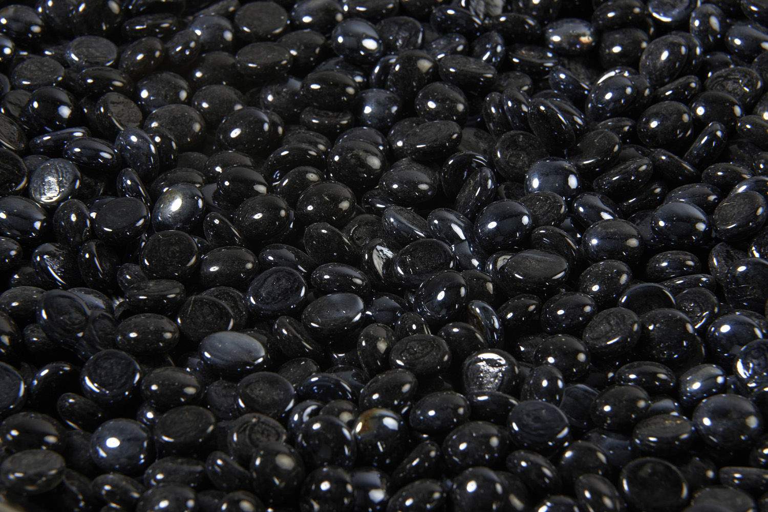 Onyx black fire glass gems, glossy oval crystals