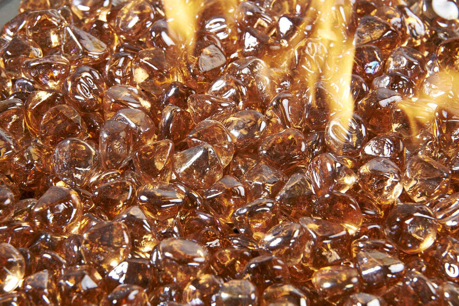 Copper fire glass diamonds with glowing flames over amber-brown glass pieces