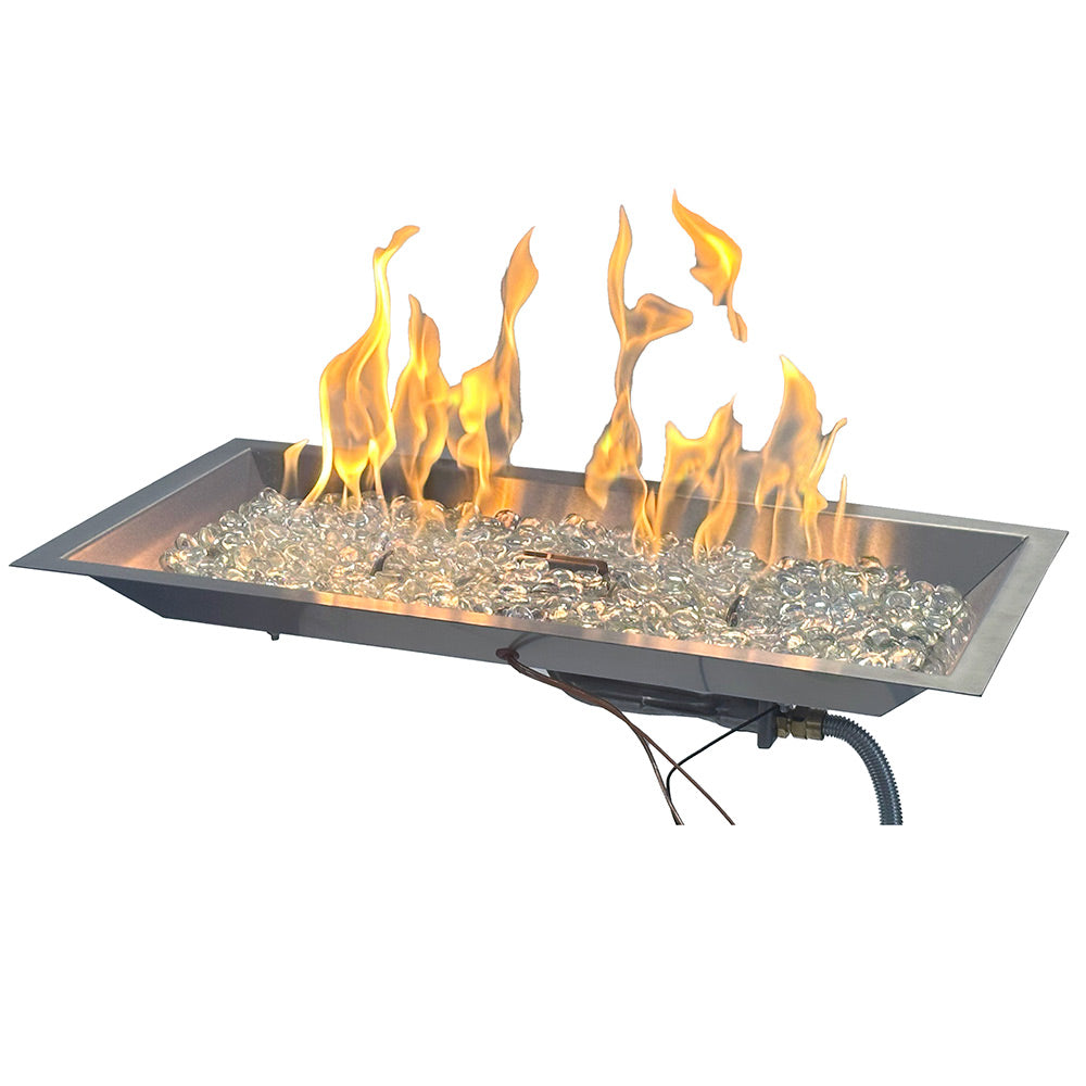 Linear gas fire pit burner with glass fire stones and bright flames in dark metal tray
