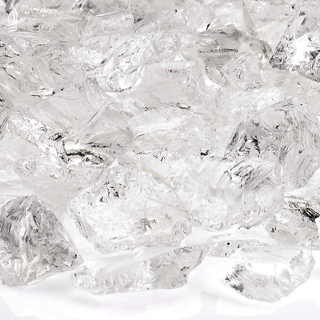 Close-up of clear ice-toned recycled fire glass chunks with reflective facets.