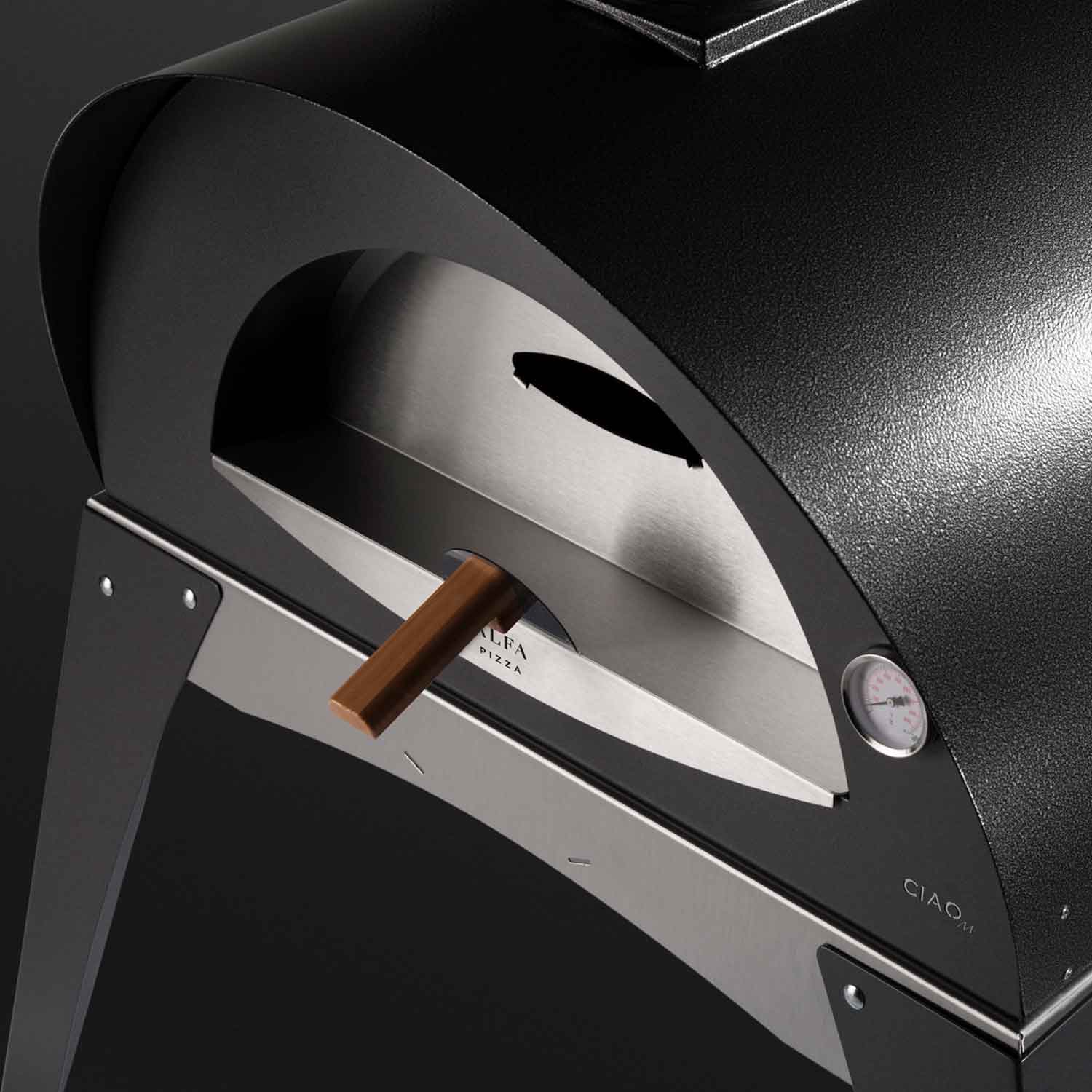 Pizza oven opening with arched black door and stainless interior plate, wood handle