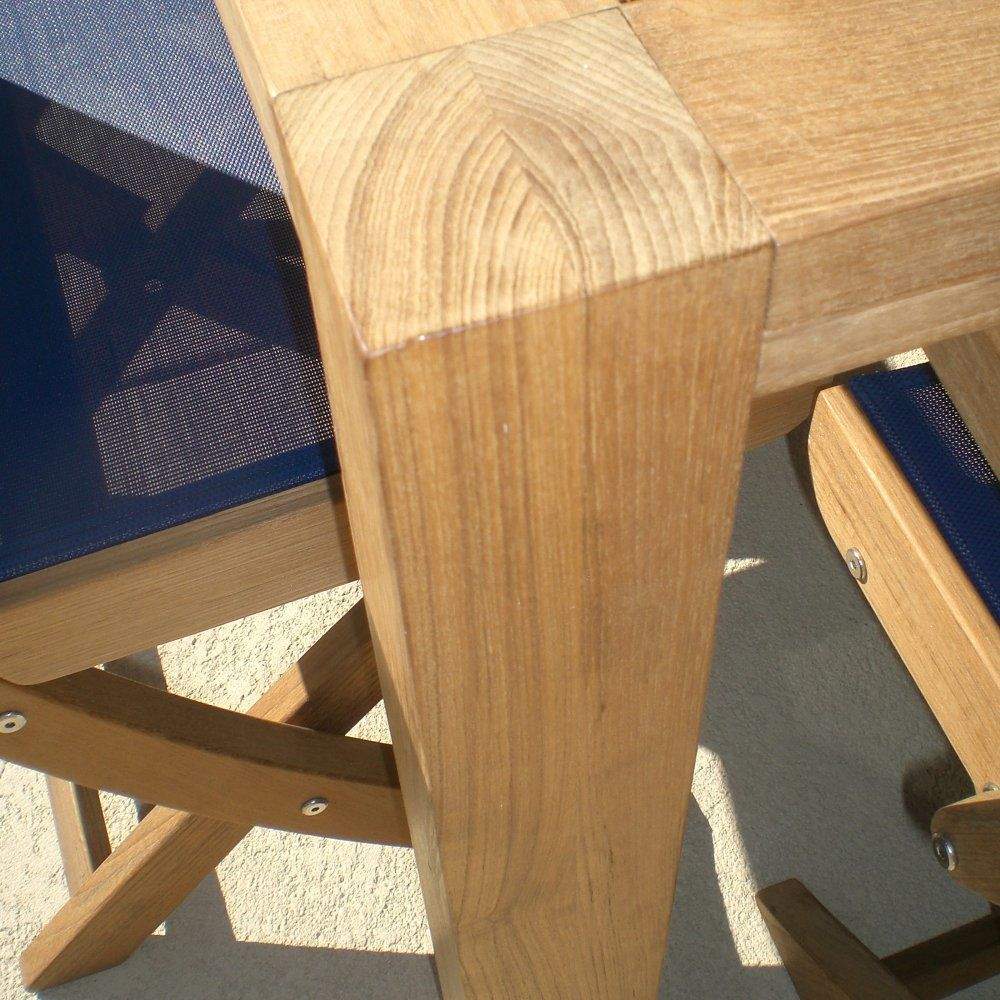 Teak table leg corner with metal hardware detail