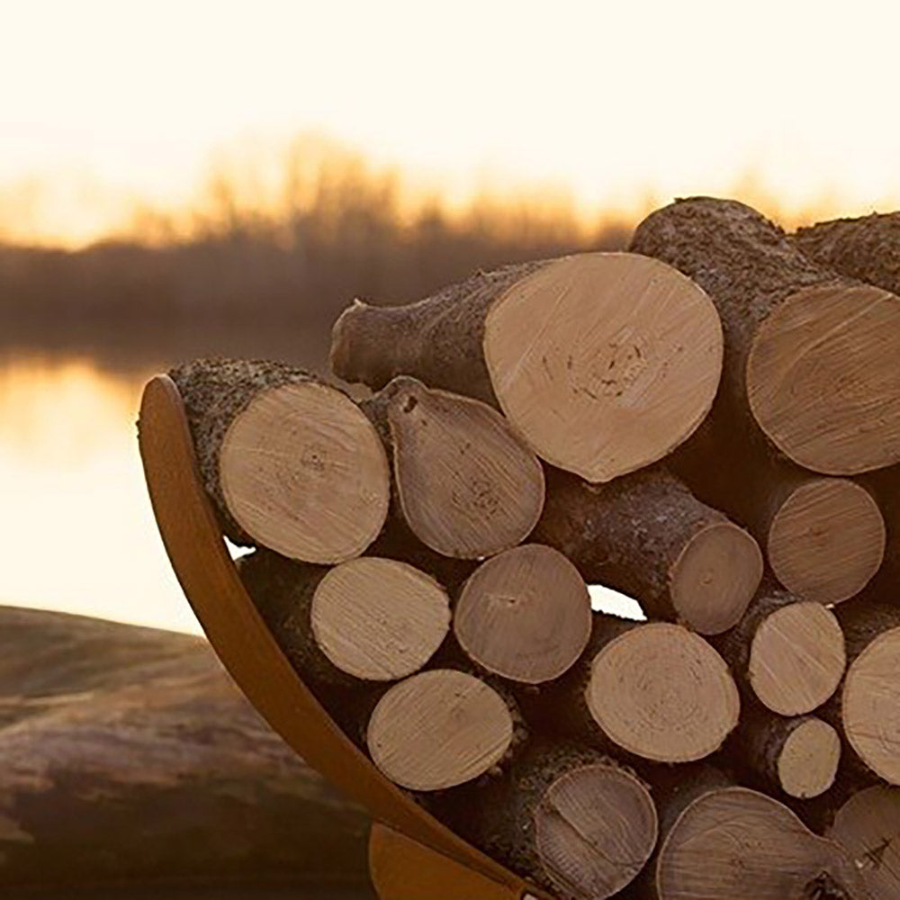 Crescent wood log rack with stacked rounds of logs on a metal stand