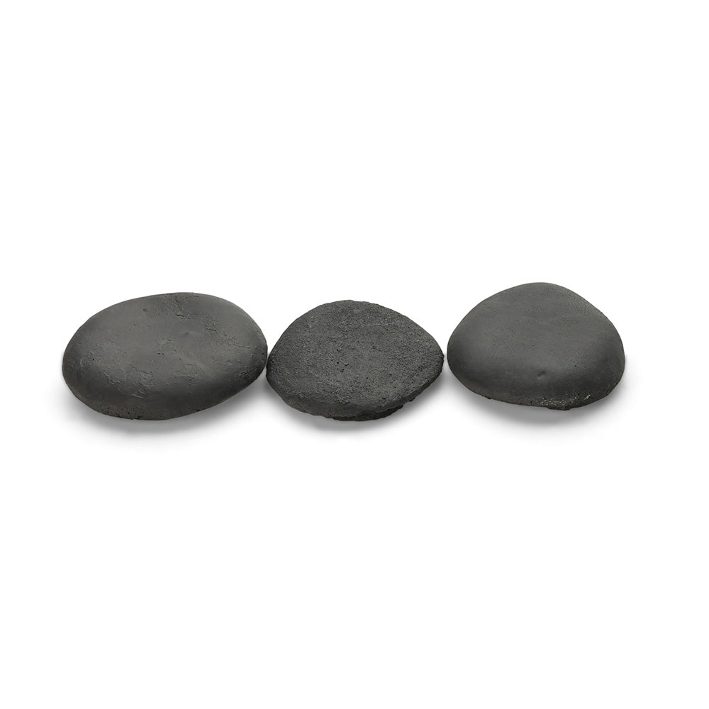 Black ceramic stones, three smooth flat pebbles with matte texture