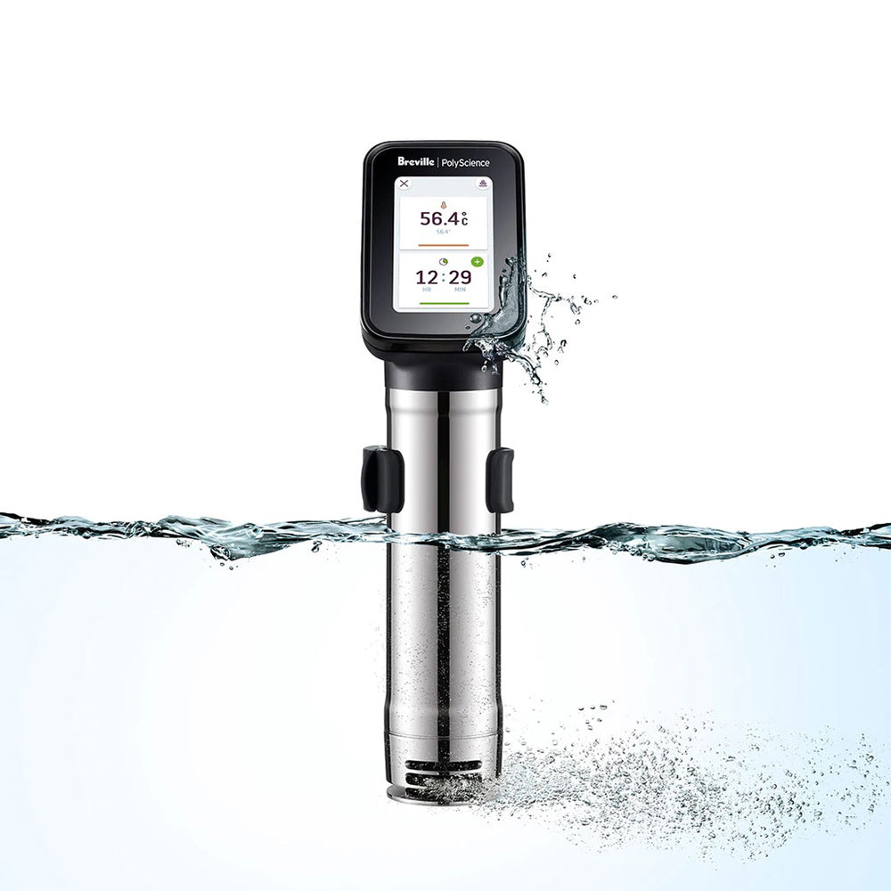 Sous vide immersion circulator spraying water; digital display on stainless-steel body