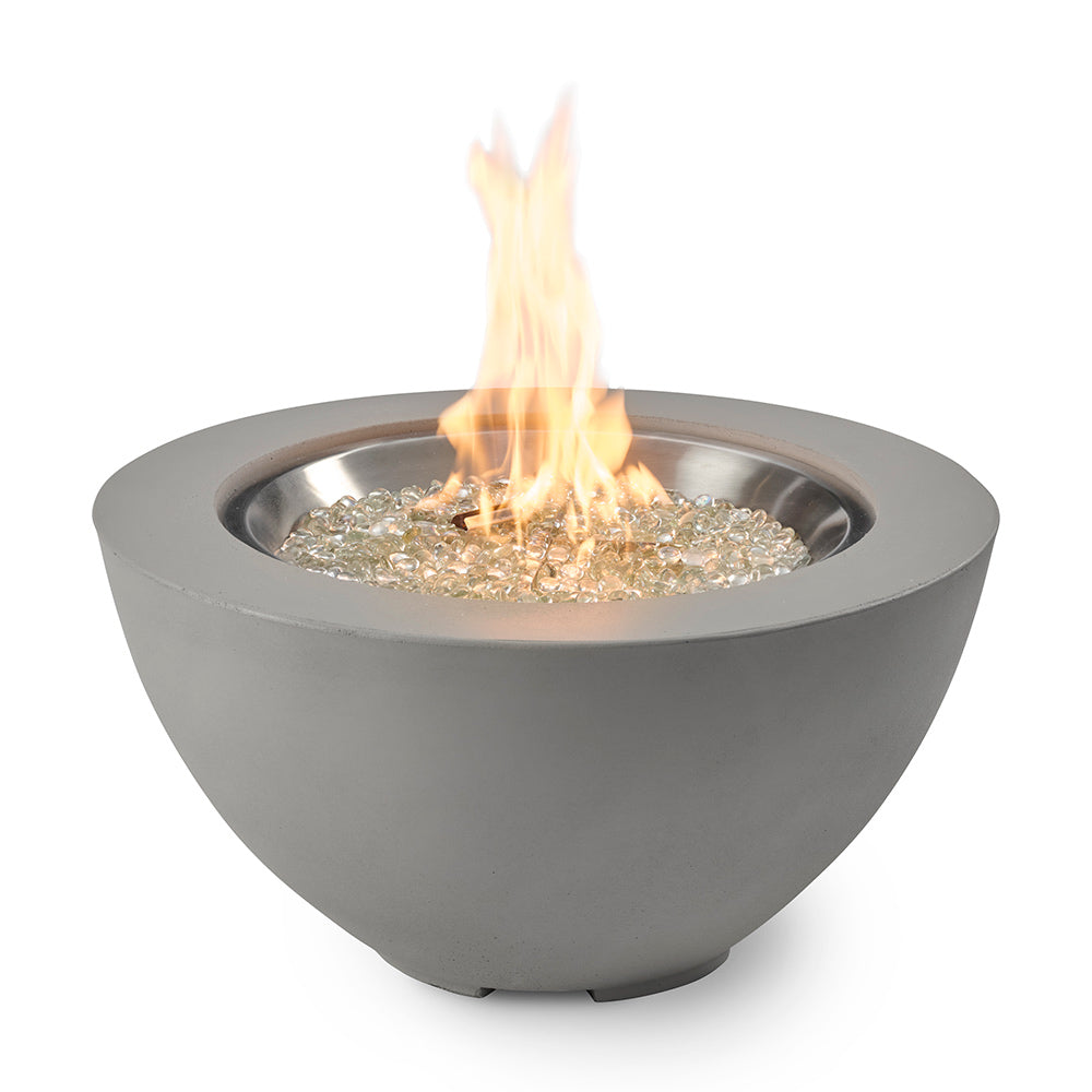 Grey bowl gas fire pit with tall flame over glass fire media