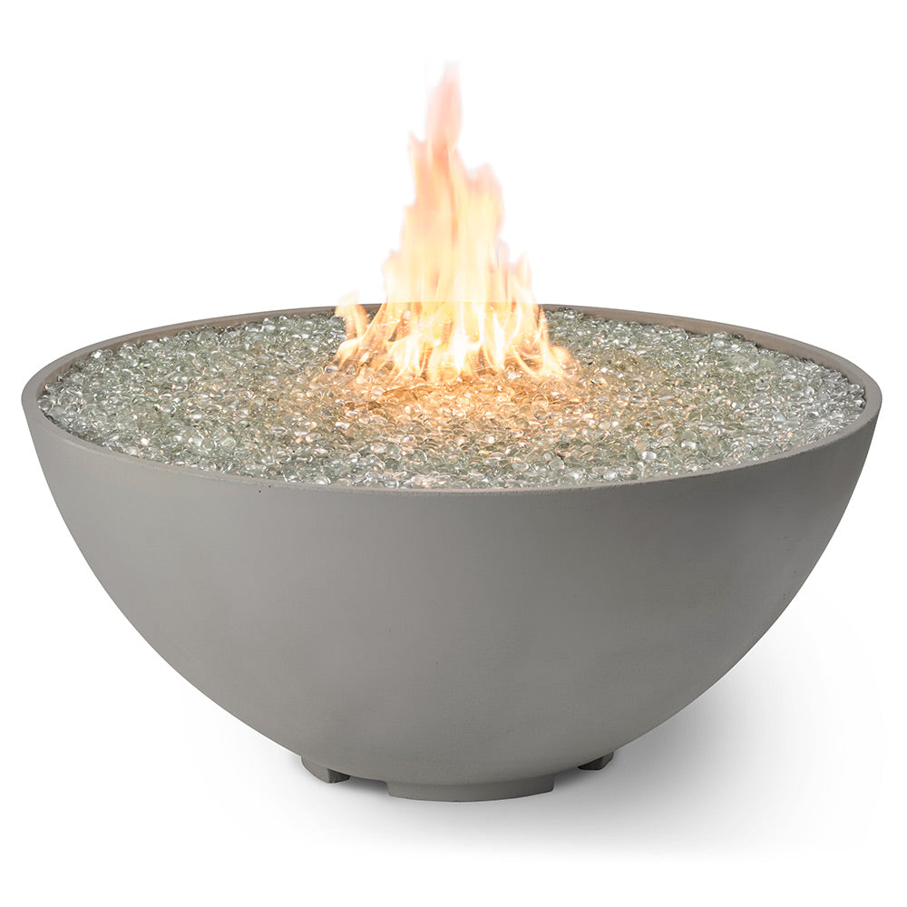 Gas fire pit with dark grey bowl and tall flame over sparkling burner surface