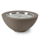 Gas fire pit bowl with taupe exterior and glowing burner with silver fire glass