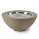Gas fire pit bowl with beige-brown exterior and glowing burner with silver fire glass
