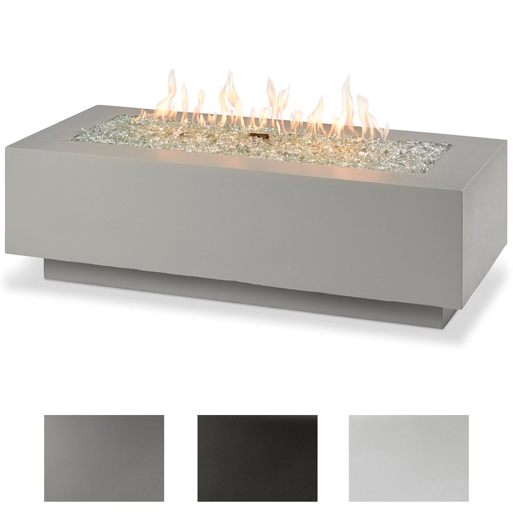 Linear gas fire pit table in light grey with glowing lava stones and flames