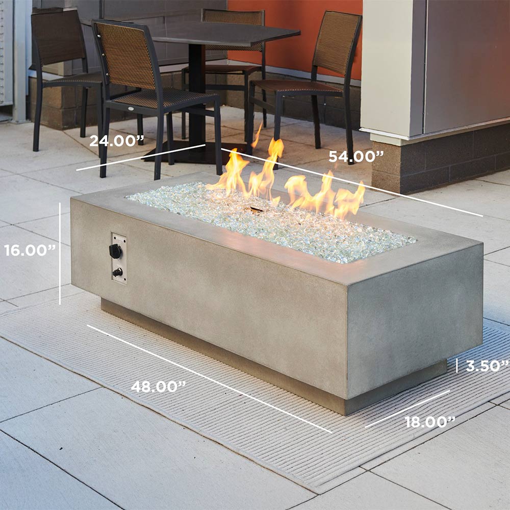Linear gas fire pit table in light grey with flames and lava stones